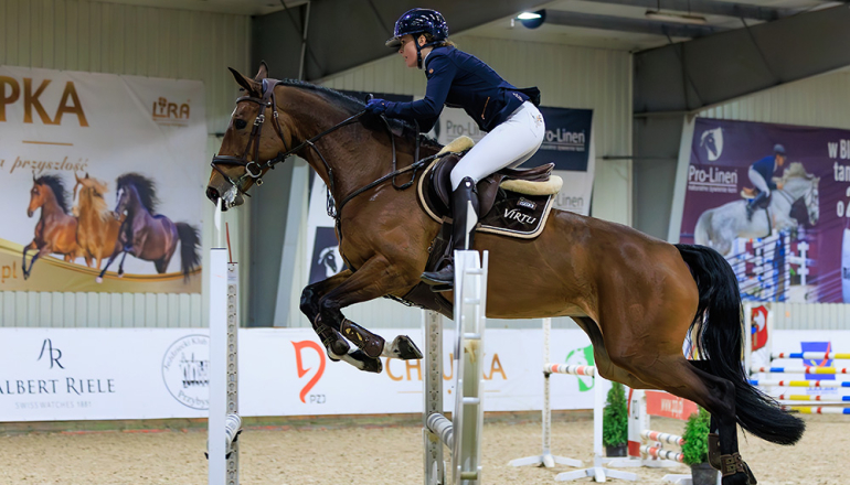 kobieta na koniu skaczącym przez przeszkody