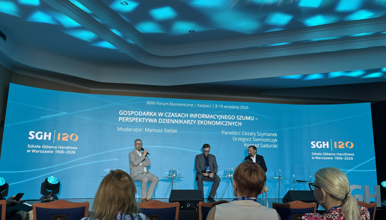 trzech mężczyzn rozmawia na panelu podczas kongresu