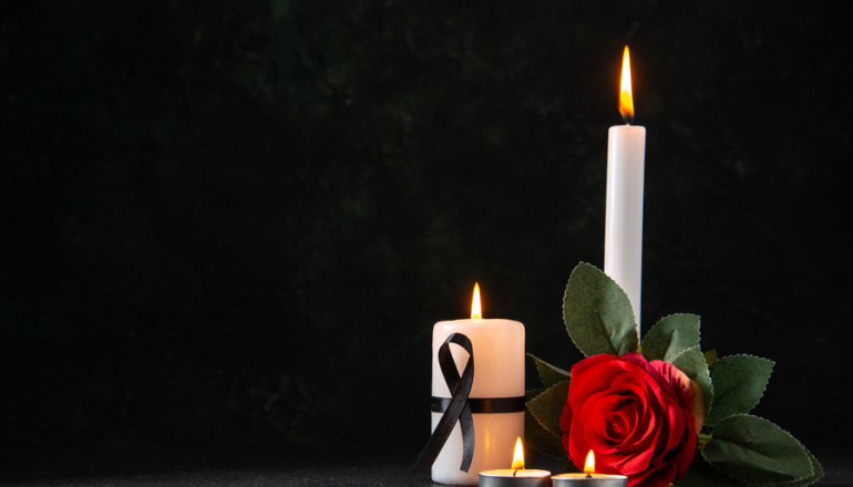 widok z przodu płonących świec z czerwonym kwiatem na ciemnej powierzchni