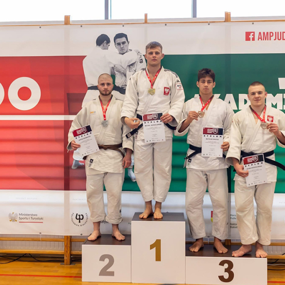 podium z zawodnikami ubranymi w kimona