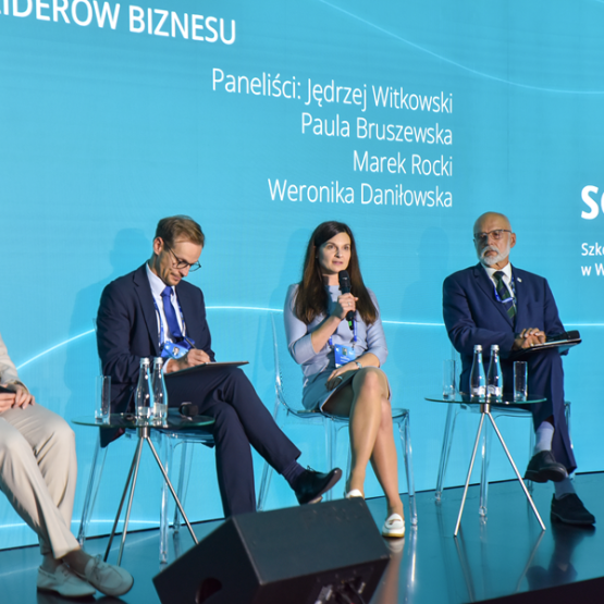 kilka osób rozmawia na panelu podczas konferencji