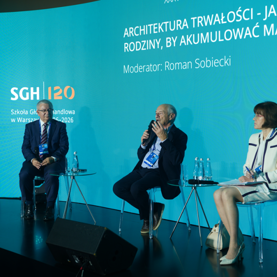 trzy osoby rozmawiają na scenie na panelu