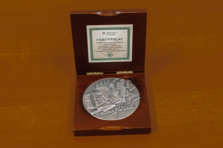 okrągły medal w drewnianym etui