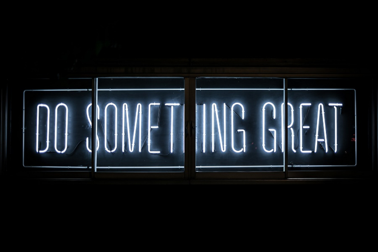 neon sign with slogan: Do something great