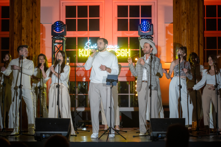 zespół śpiewa na scenie na koncercie świątecznym