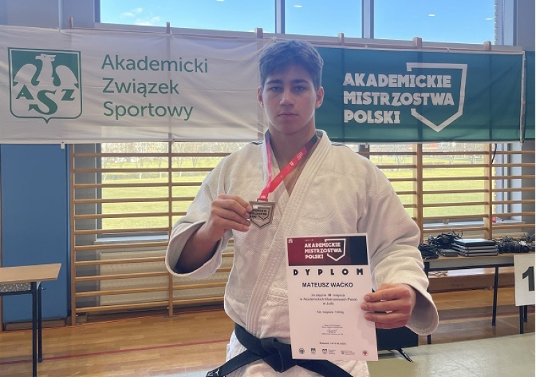 judoka pozuje do zdjęcia z medalem i dyplomem