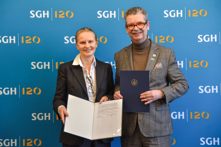 mężczyzna i kobieta pozują do zdjęcia z podpisanym porozumieniem